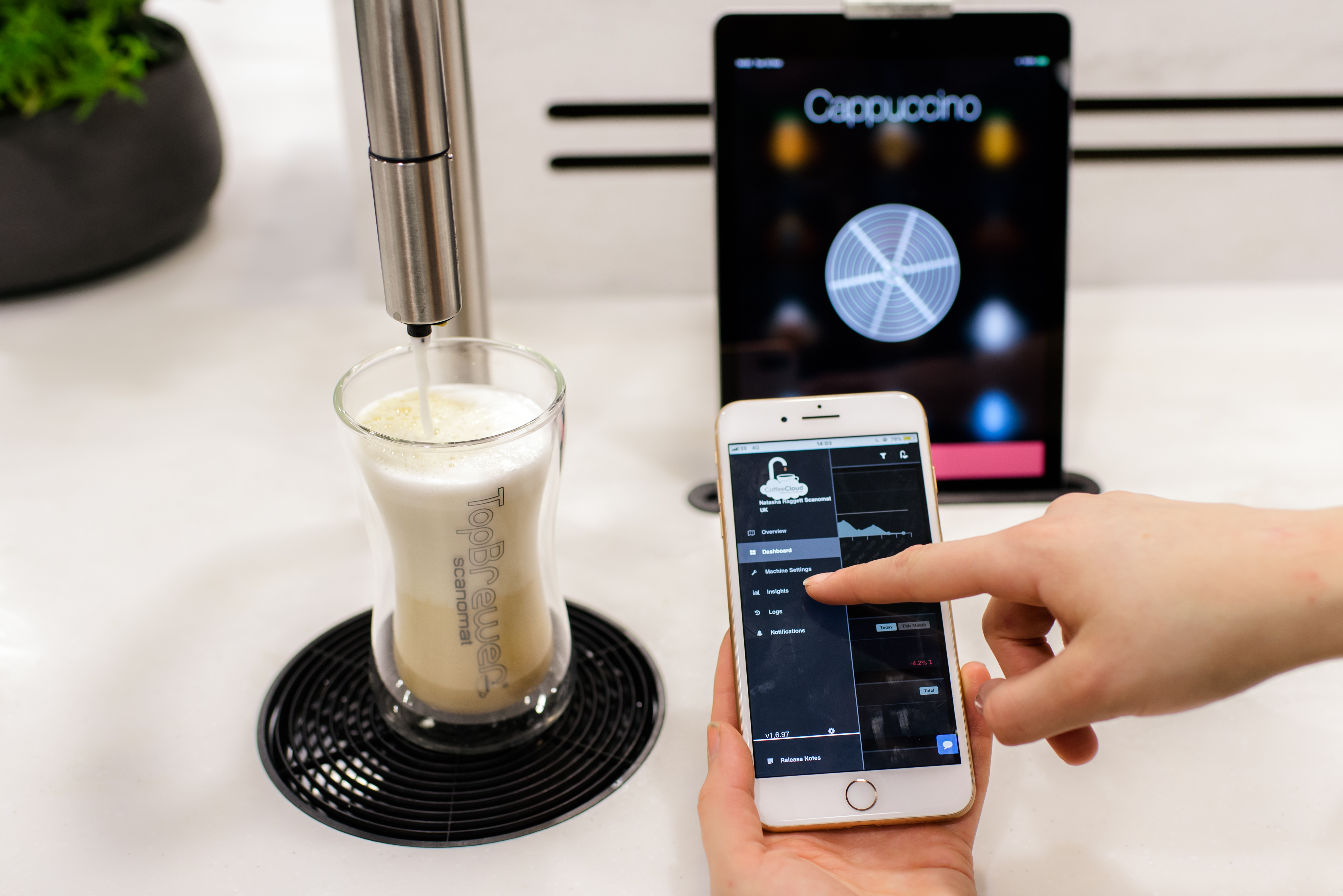 CoffeeCloud close up, showing menu on the app with TopBrewer in the background
